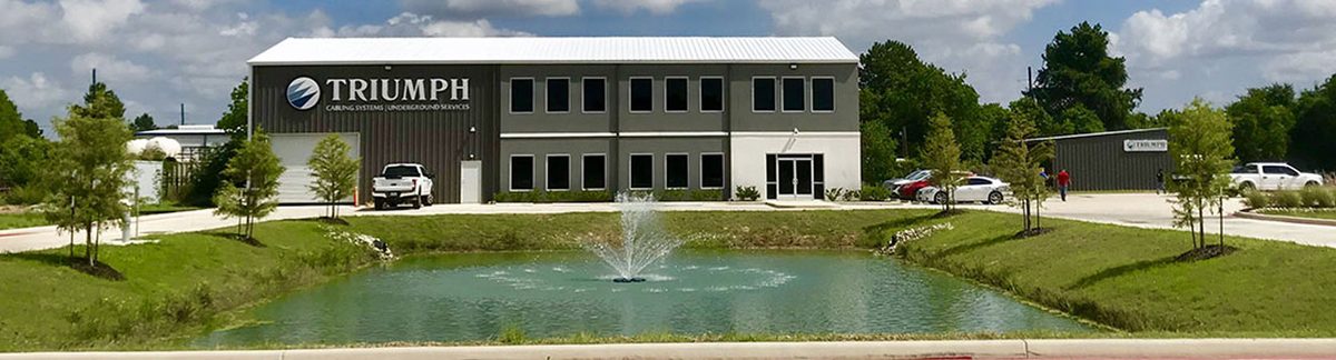 The Triumph Cabling Systems headquarters building in Houston, seen across its landscaped pond