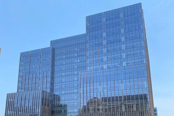 Blue glass state office tower in Austin, seen from street level